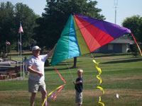 Carrolltown back pain free grandpa and grandson playing with a kite